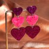 boucles d'oreilles avec cœur pourpre