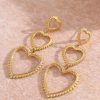 boucles d'oreilles pendantes plus 3 cœurs